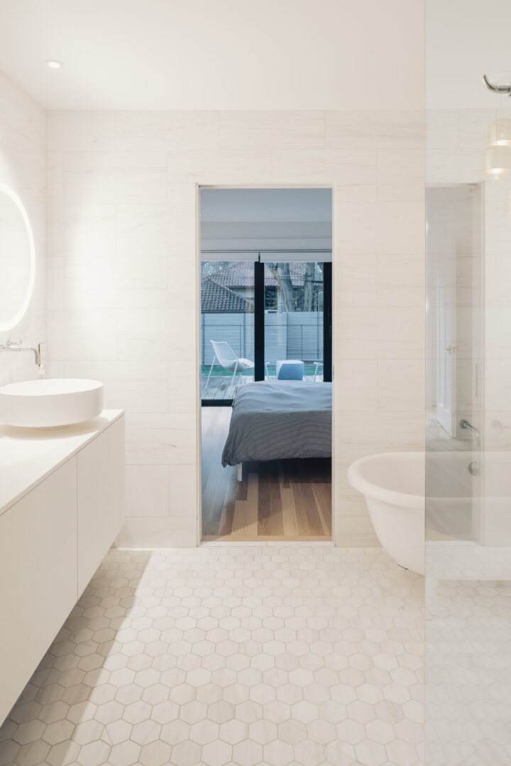 white bathroom with rug bathtub and shower curtain